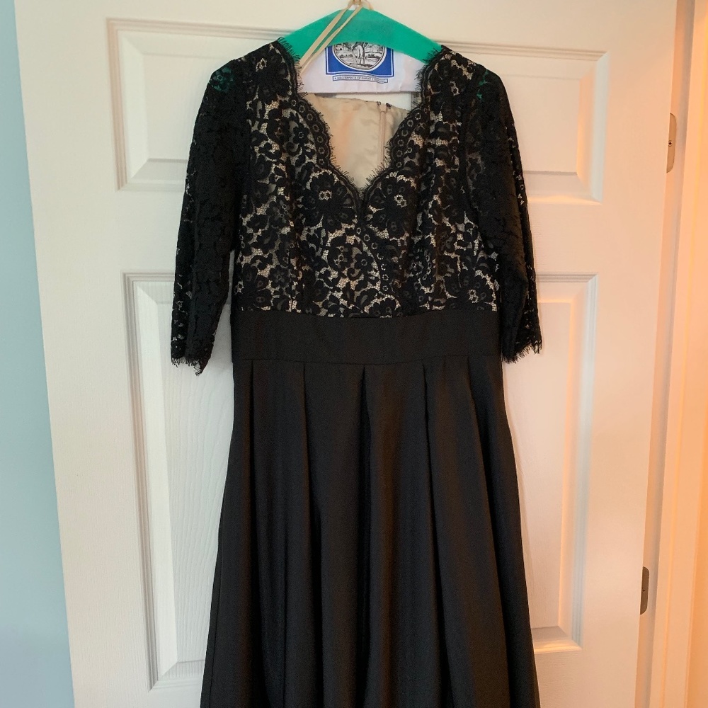 Formal  black floor length gown, with sleeves.